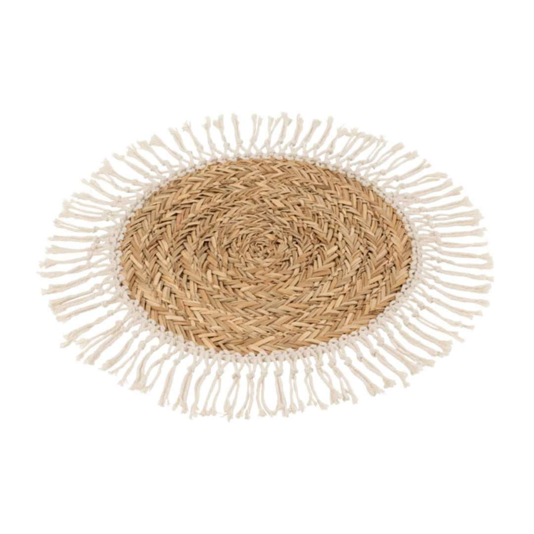 Top view of Tulum Table Mat made of rattan with cotton fringe.