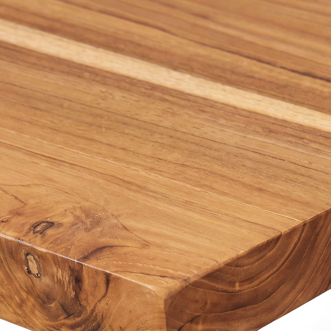 Close-up of the Tupai console tabletop showing the warm natural grain, knots, and organic teak wood edge
