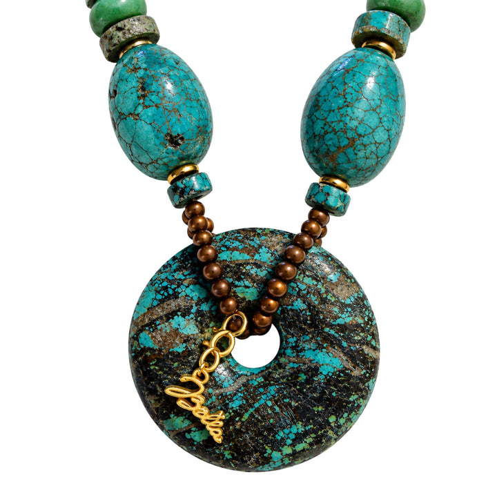 Close-up of the circular turquoise pendant and gold-filled details