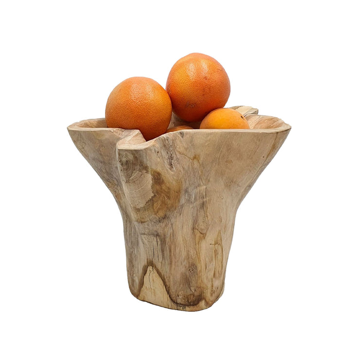 Ukko teak bowl used as a centerpiece holding fruit.