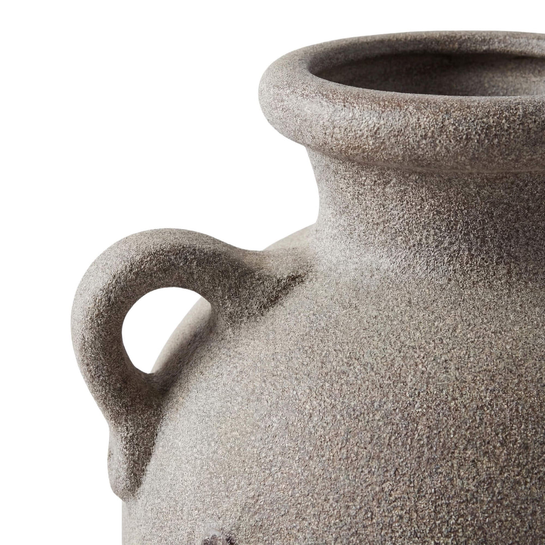 Close-up detail of the vase handle and textured terracotta surface.