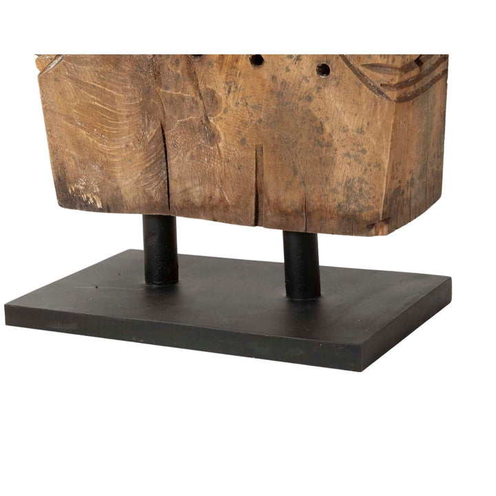 Close-up of Unkulunkulu sculpture showing facial carving and wood texture.