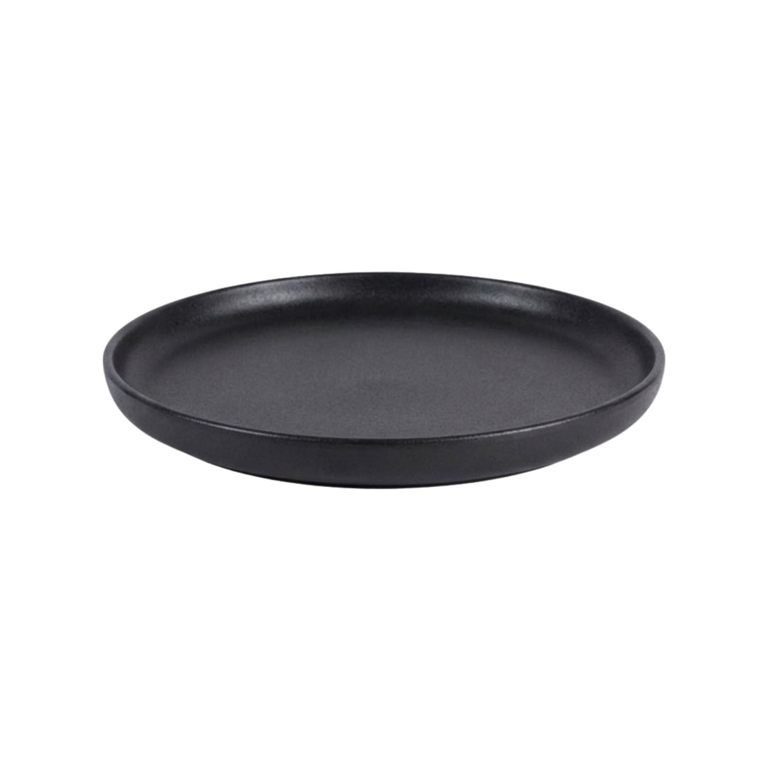 Side view of black ceramic plate with smooth matte surface.
