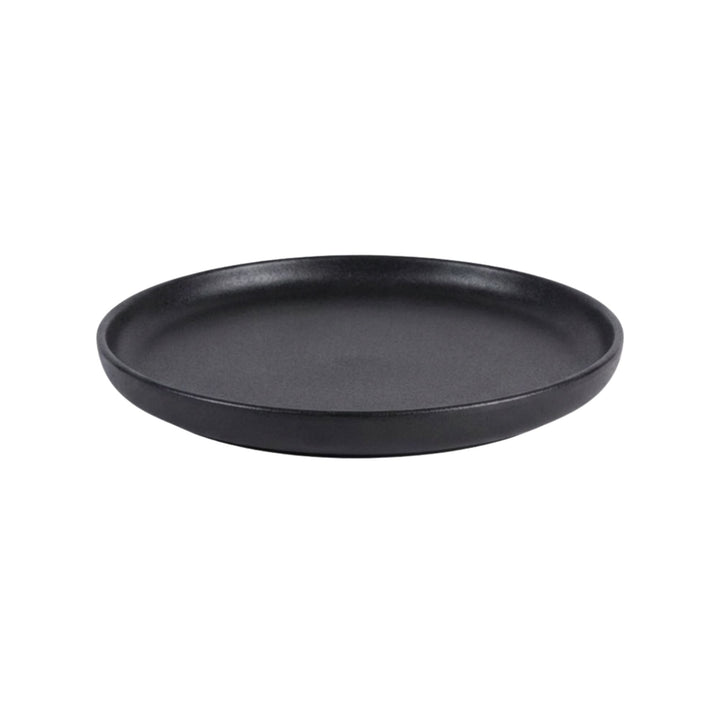 Side view of black ceramic plate with smooth matte surface.