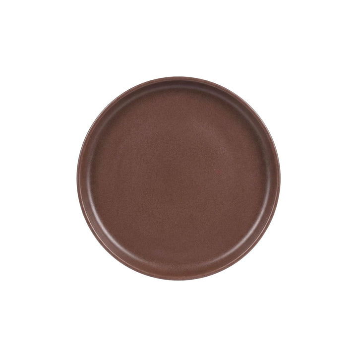 Top view of chocolate brown ceramic dessert plate with smooth matte finish.