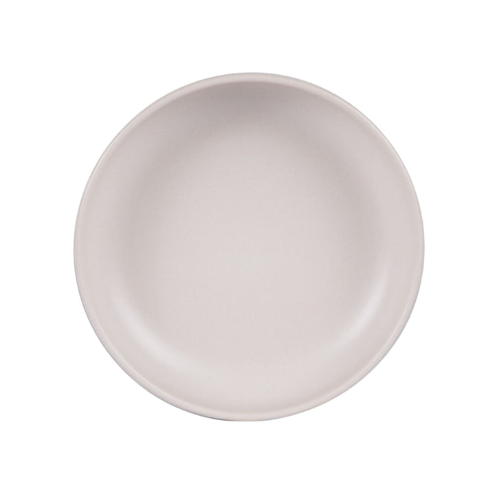Top view of Uno Cream ceramic bowl highlighting its shallow profile and smooth texture.