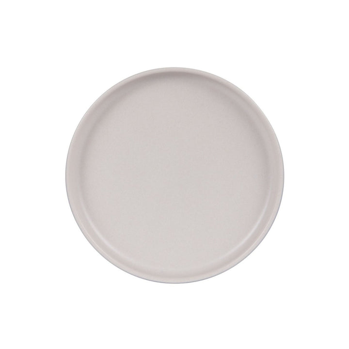 Top view of cream ceramic dessert plate showing clean lines and soft matte finish.
