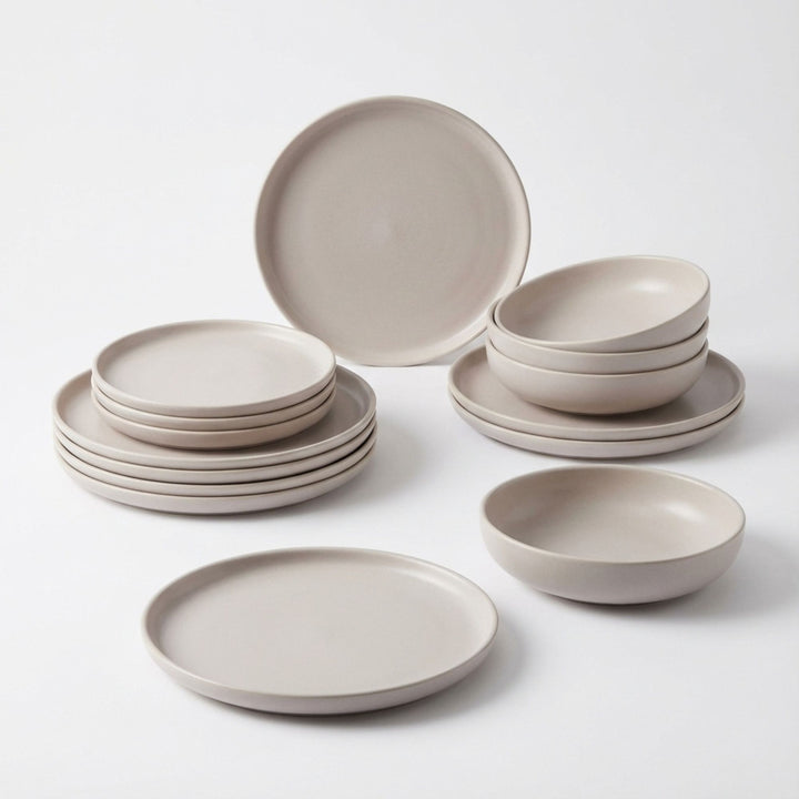 Set of Uno Cream ceramic tableware arranged on a white background.