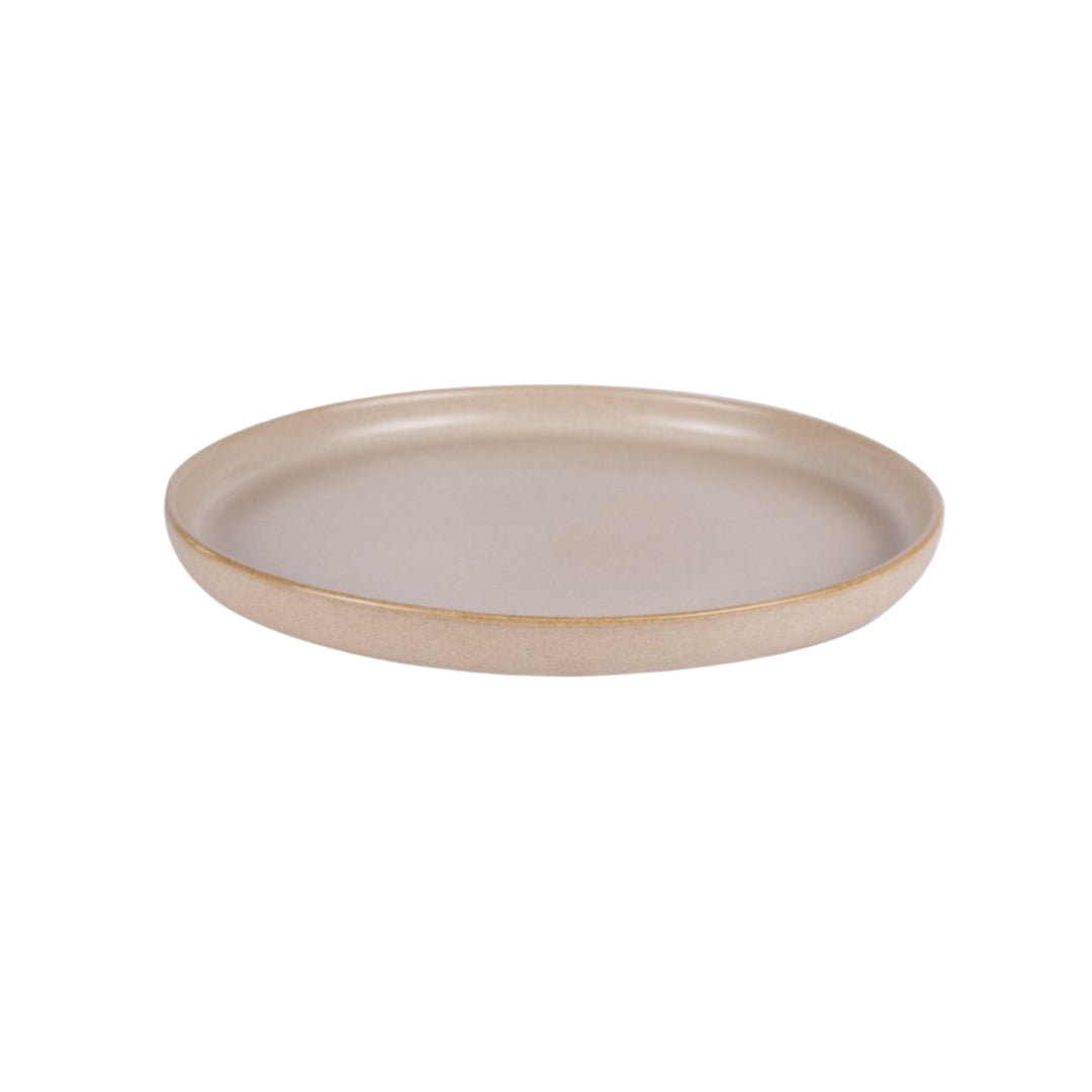 Side view of sand-colored ceramic plate with soft matte texture.