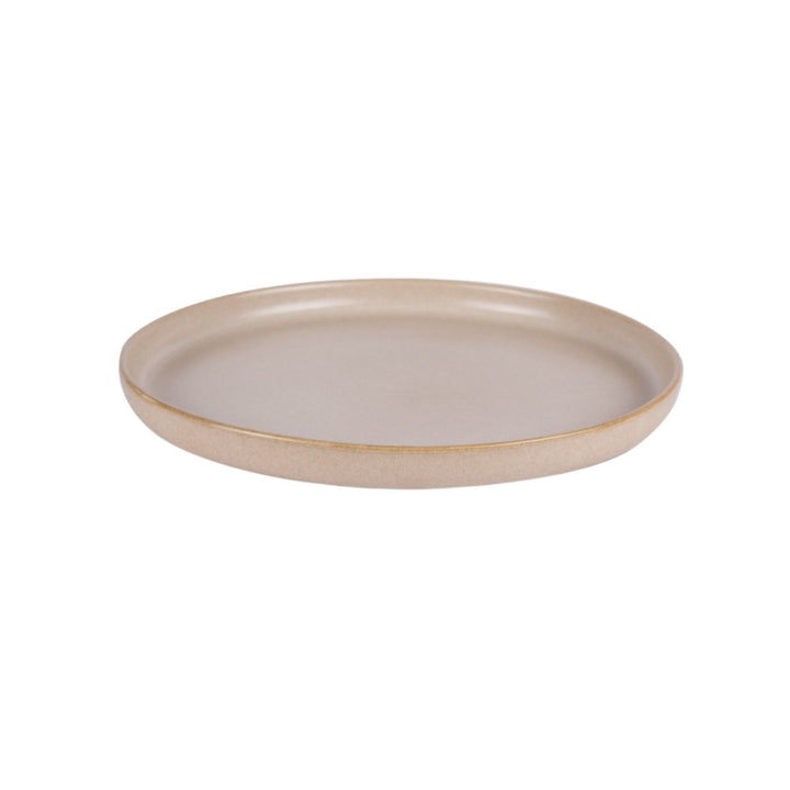 Side view of sand-colored ceramic plate with soft matte texture.