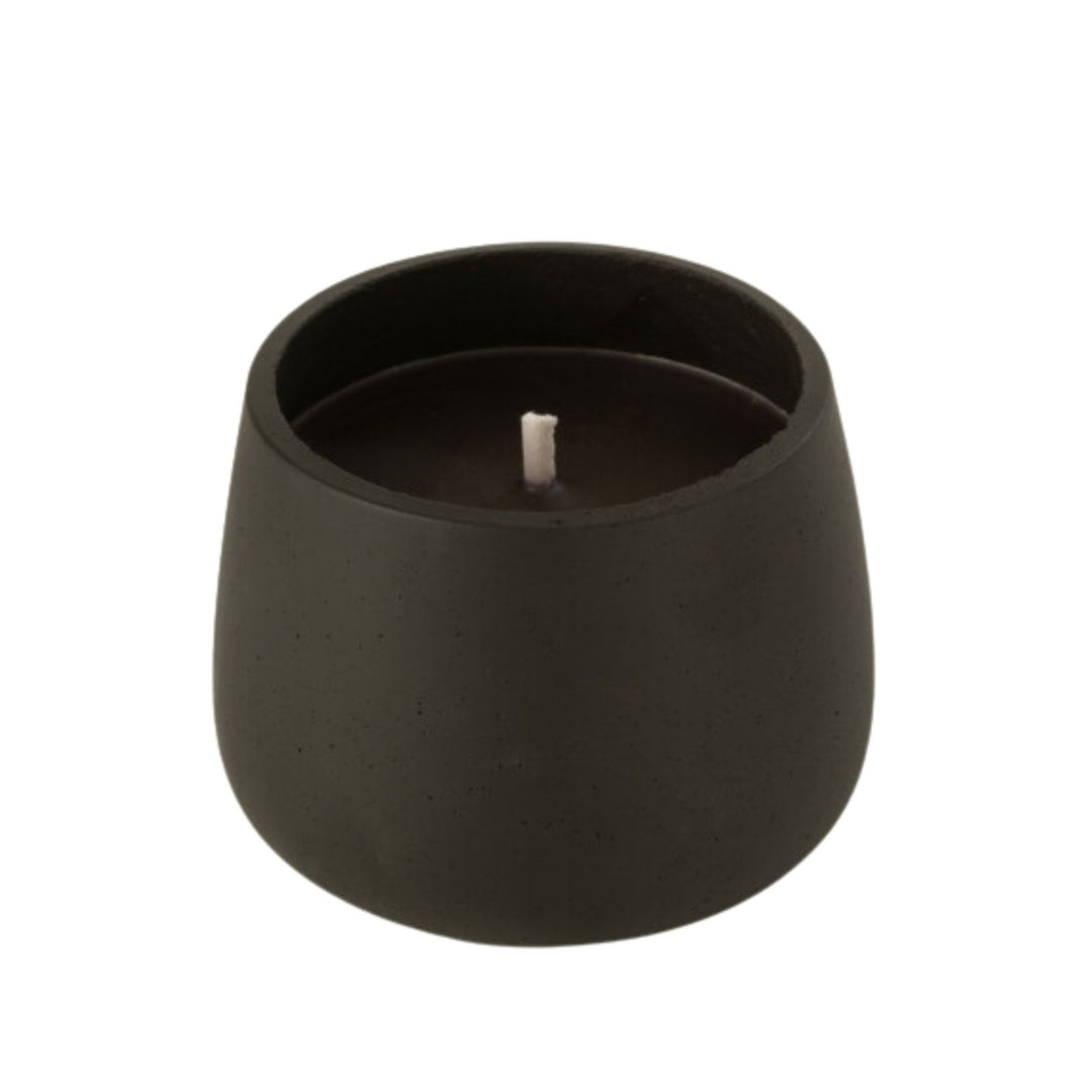 Front view of the Vamizi Black Candle in a matte black cement container.