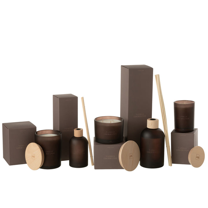 Flat-lay composition with the diffuser, candles, and accessories in warm ambient lighting.