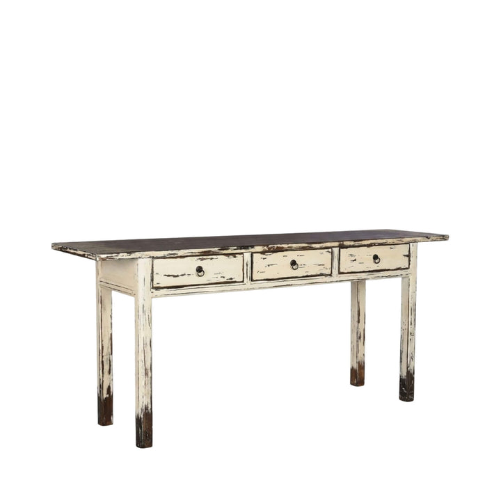 Front view of the Varadero console table showing its distressed white finish, dark top, and three drawers.