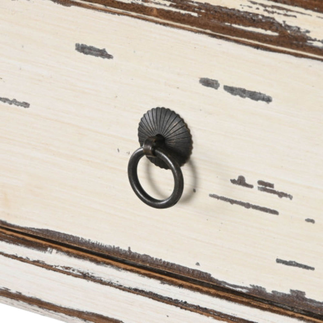 Close-up detail of the drawer front with metal ring handle and distressed painted finish.