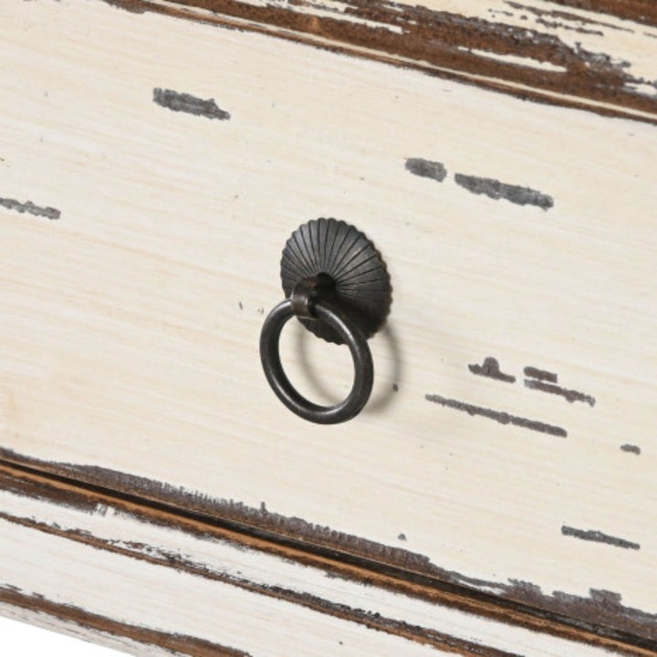 Close-up detail of the drawer front with metal ring handle and distressed painted finish.
