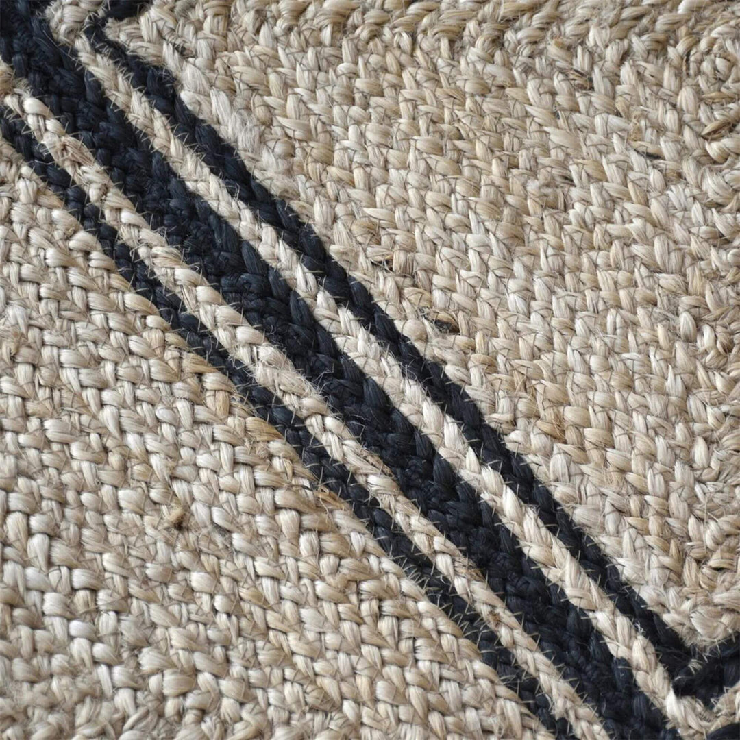 Close-up of the Velsao Rug highlighting the woven jute texture and contrasting dark lines.