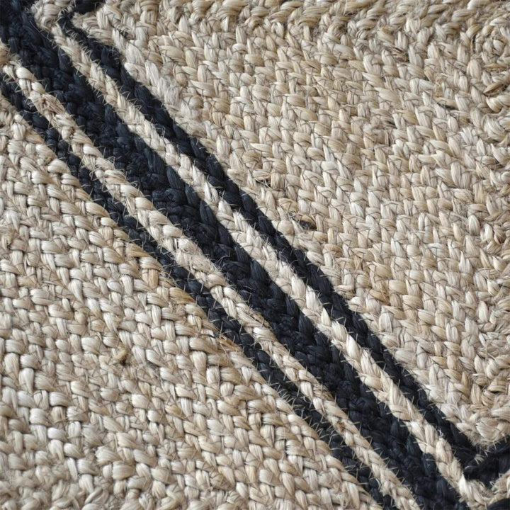 Close-up of the Velsao Rug highlighting the woven jute texture and contrasting dark lines.