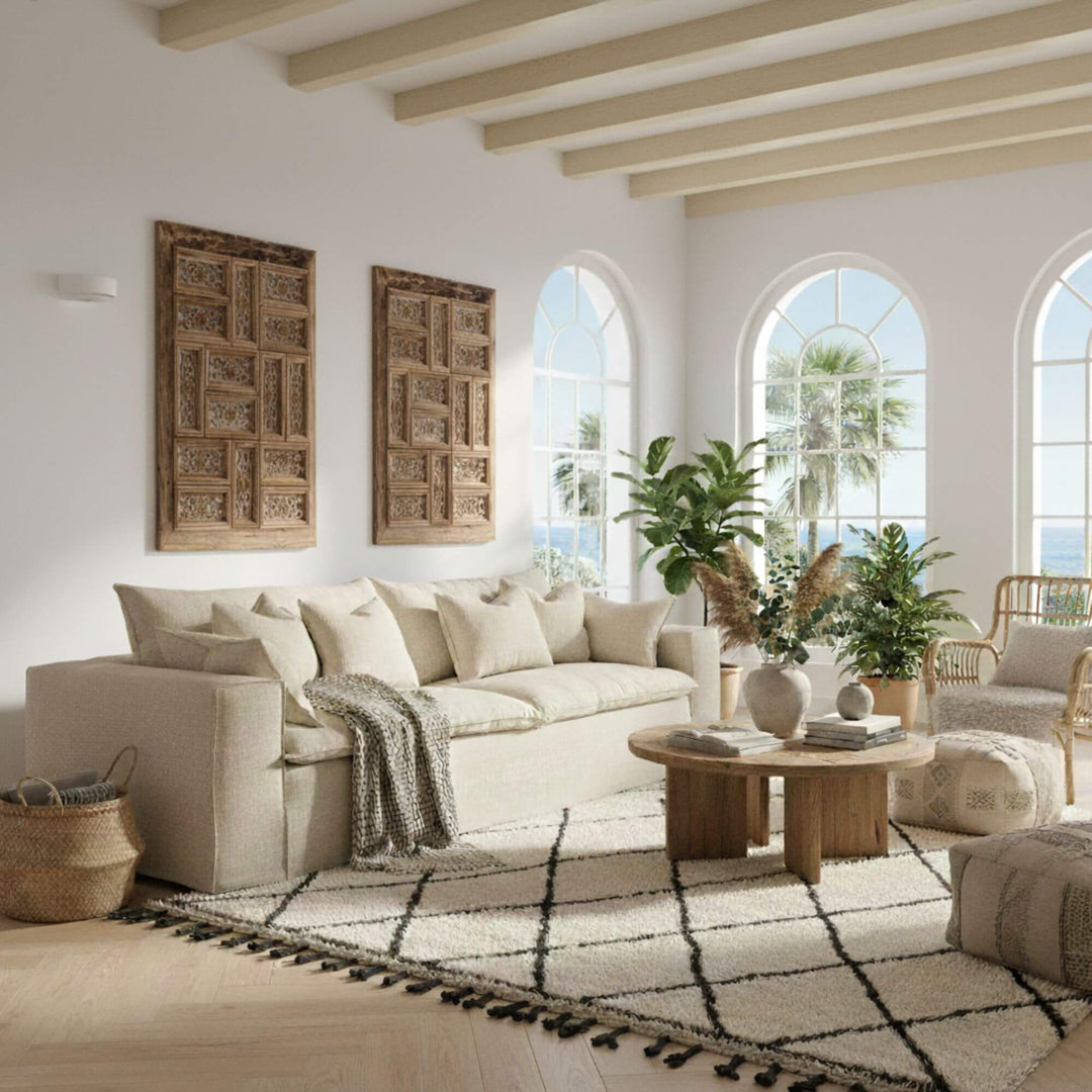 Cozy living room with beige Vicenza sofa, wooden coffee table, and decorative elements.
