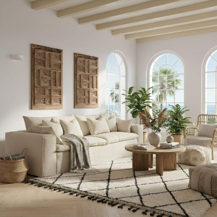 Cozy living room with beige Vicenza sofa, wooden coffee table, and decorative elements.