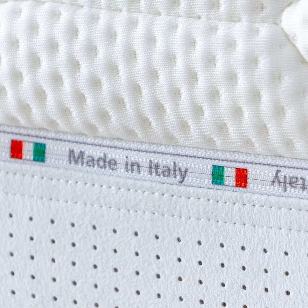 Angled view highlighting the mattress thickness and breathable fabric upholstery.