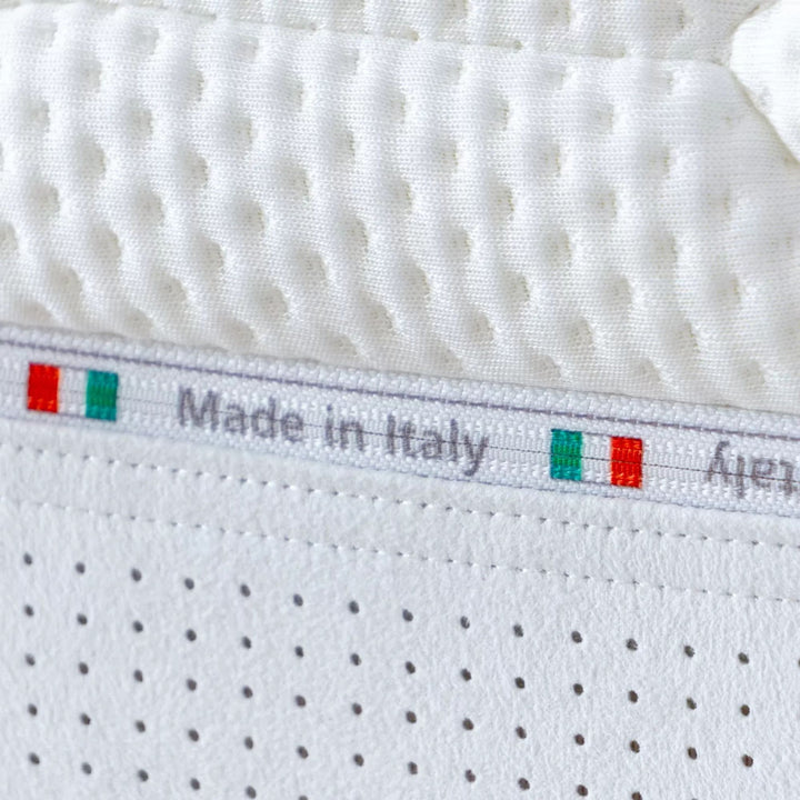 Angled view highlighting the mattress thickness and breathable fabric upholstery.