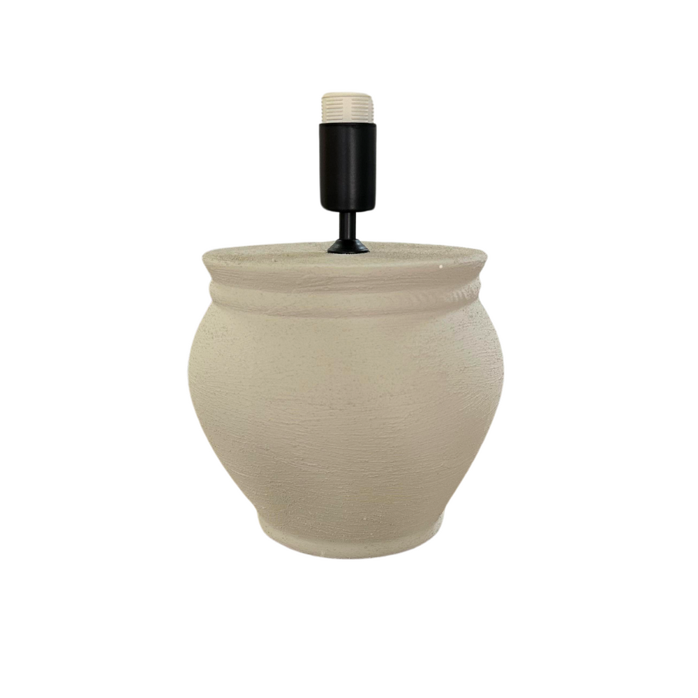 A beige ceramic Vison table lamp with a round base, a cylindrical screen, and a black switch.