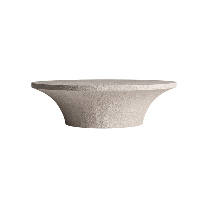 Front view of the Volka coffee table showcasing its sculptural cement form and wide circular top.