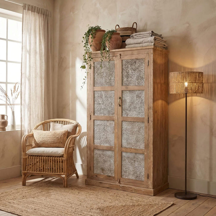 Styled interior setting showing the White Briss wardrobe beside a chair and natural decor.