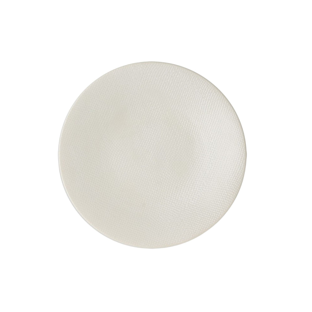 Top view of white textured ceramic plate.
