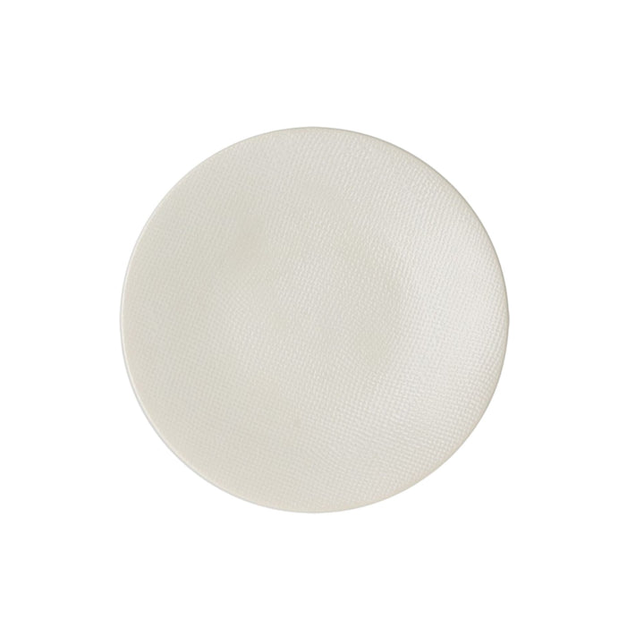 Top view of white textured ceramic plate.
