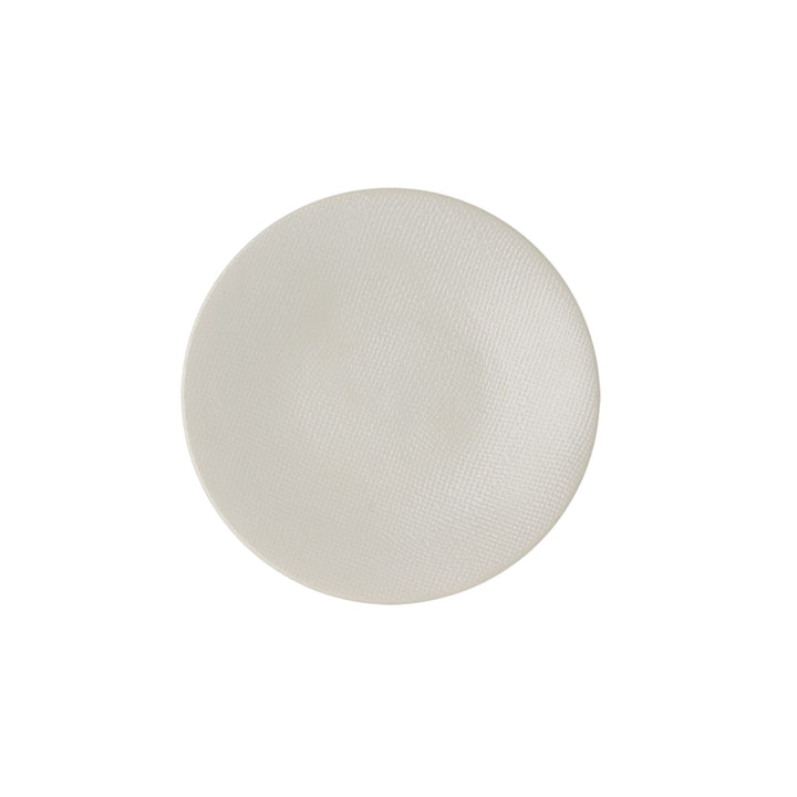 Top view of white textured ceramic dessert plate.