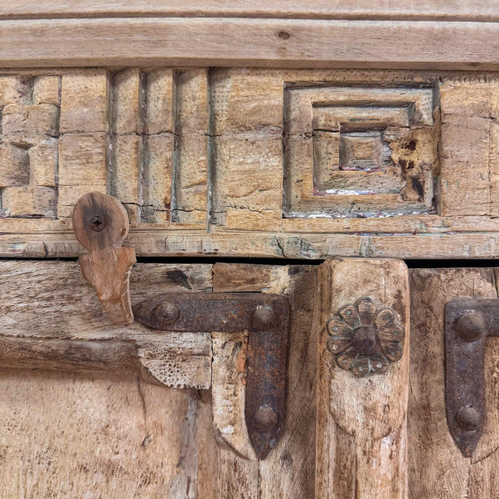 Close-up of carved upper detail on the reclaimed wood wardrobe.
