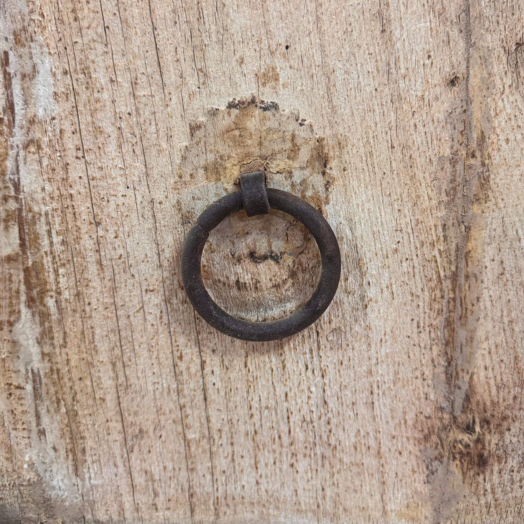 Close-up of rustic ring handle on reclaimed wood door.