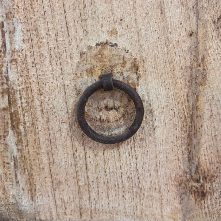 Close-up of rustic ring handle on reclaimed wood door.