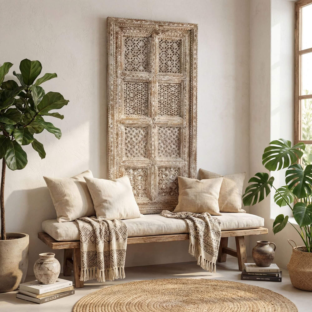 Interior setting showing the tall carved wood panel placed behind a bench in a warm living space.