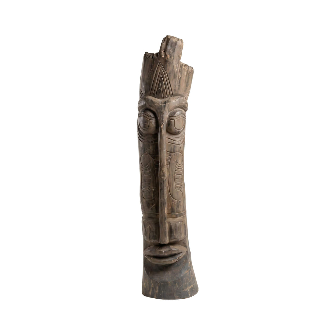 Front view of the Zon wood sculpture showing its tall hand-carved form and expressive facial details.