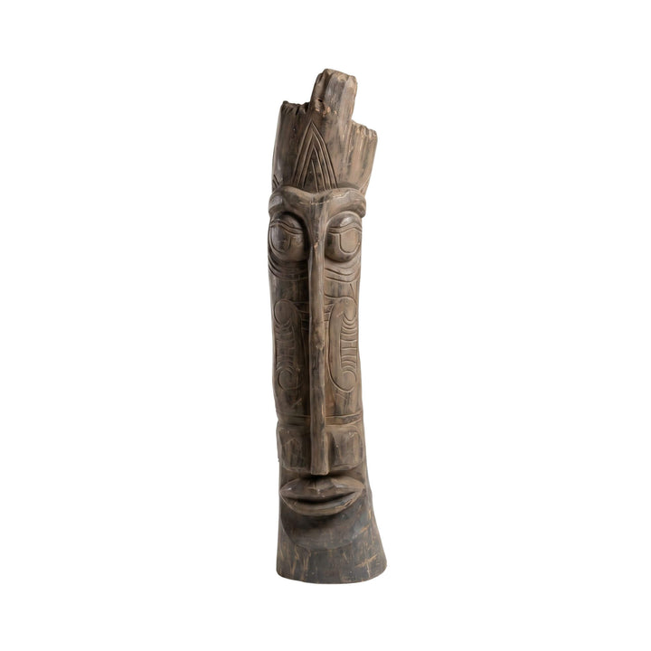 Front view of the Zon wood sculpture showing its tall hand-carved form and expressive facial details.