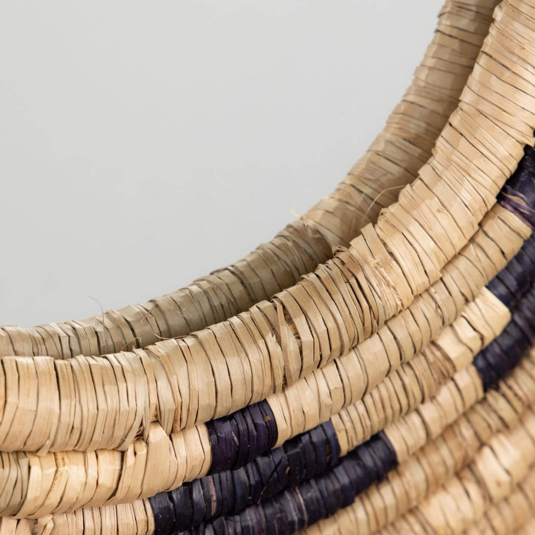 Close-up of the Zuri Mirror I highlighting the layered seagrass weave and curved circular frame