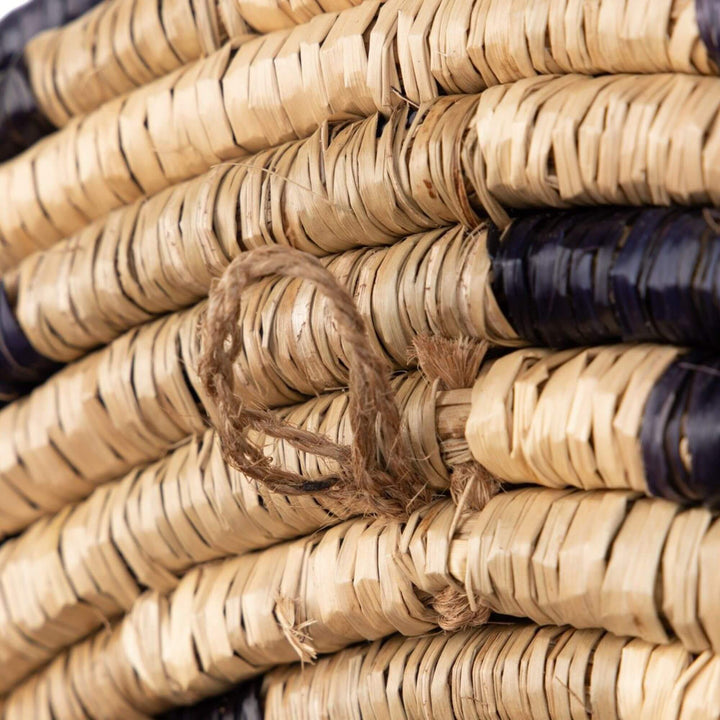 Detail of the Zuri Mirror I showing the natural handwoven seagrass fibers and contrasting dark pattern