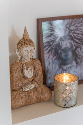 Ibi Buddha wooden figure styled on a shelf creating a calm and spiritual atmosphere.
