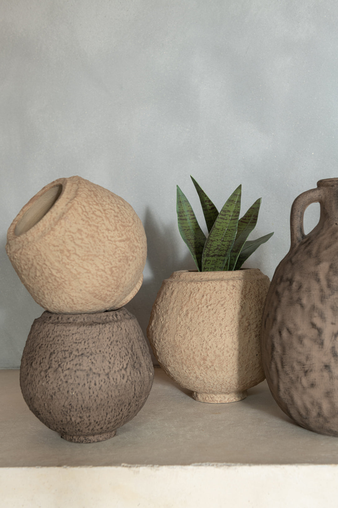 Styled view of the Kano Rustic Pot in terracotta with compact rounded shape.