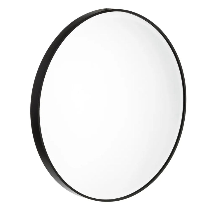 Angled view of the New York round mirror showing its slim black aluminum frame and clean circular design.
