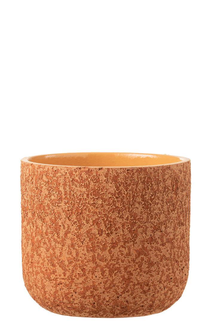 Front view of the orange rustic ceramic pot showing its rounded shape and textured surface.