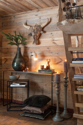 Umawa bull decorative stand styled in a rustic interior setting.